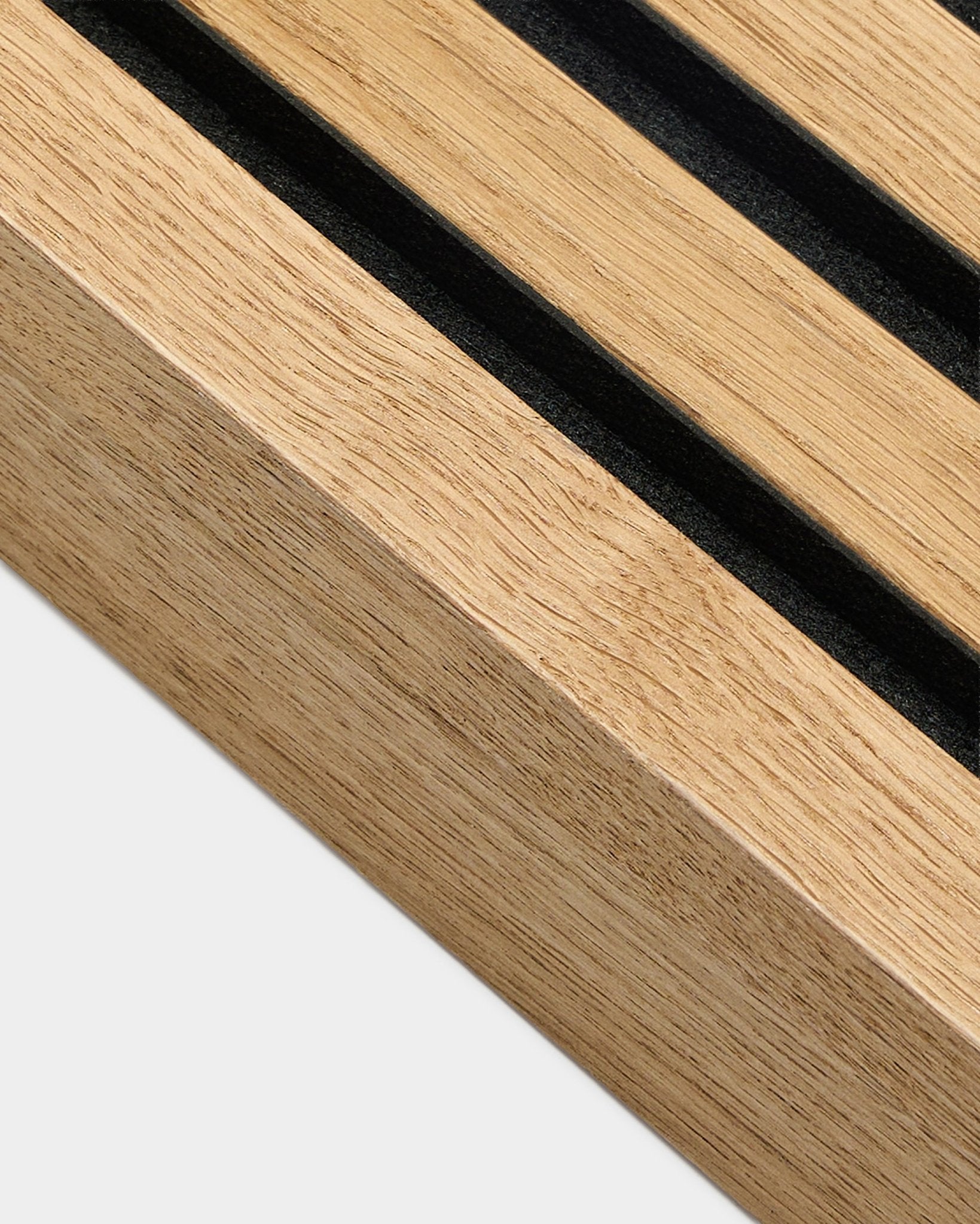 Close-up of WoodUpp Akupanel acoustic panel in Rustic Brown Oak, 6.7 cm-wide end lamella with parallel black grooves and textured wood grain.